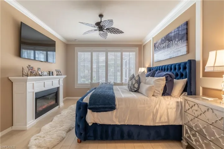 Bedroom featuring ceiling fan and ornamental molding