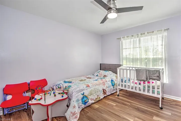 Bedroom with ceiling fan and wood-type flooring
