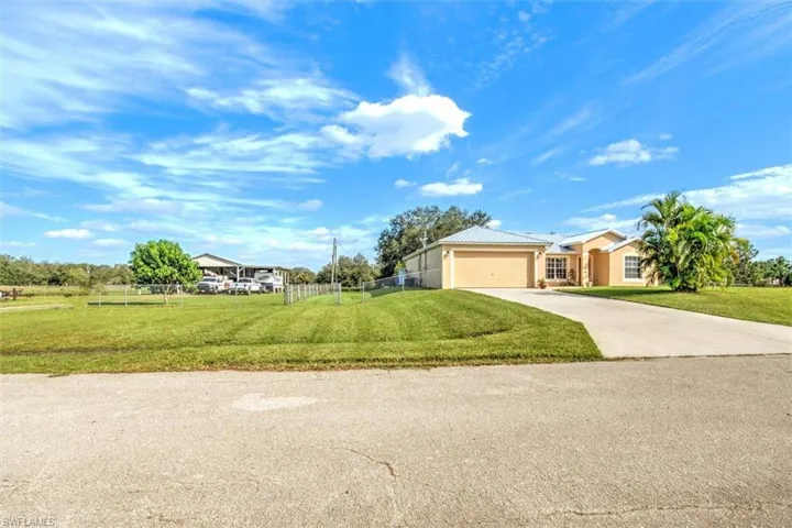 Ranch-style home with a front yard and a garage