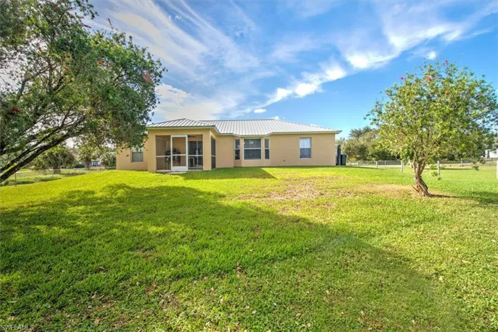 Back of property with a yard
