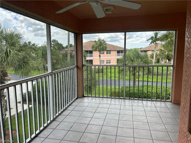 Unfurnished sunroom featuring a ceiling fan and plenty of natural light