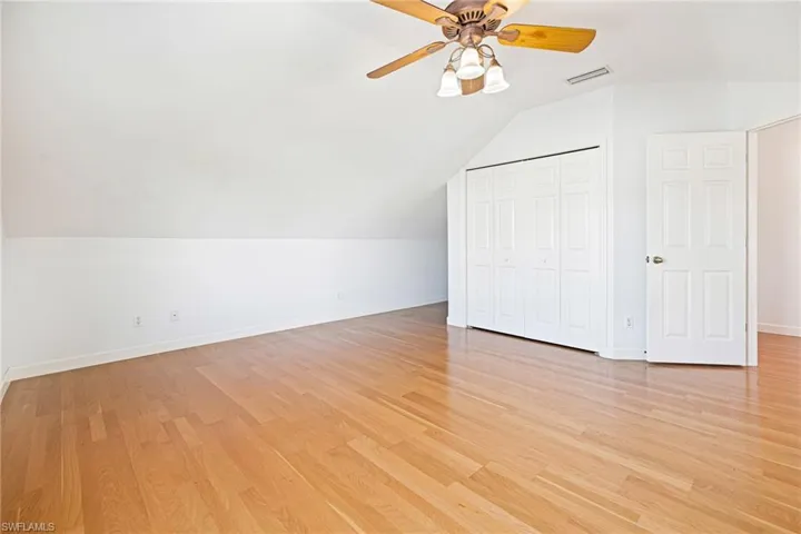 Second floor guest bedroom with lofted ceilings.
