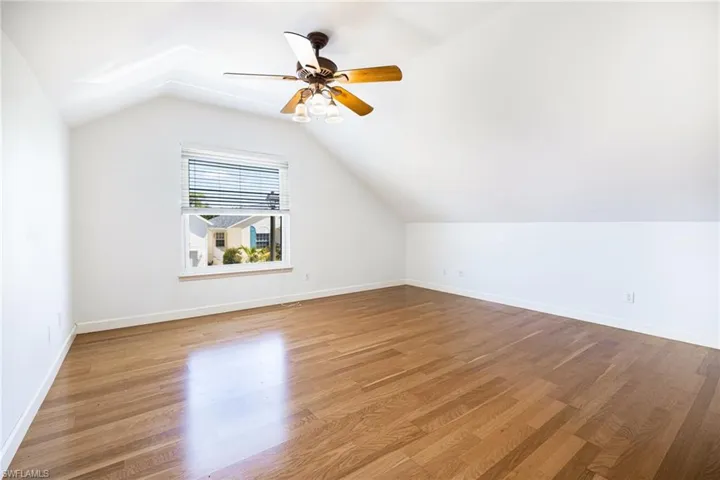 Second floor guest bedroom with lofted ceilings.