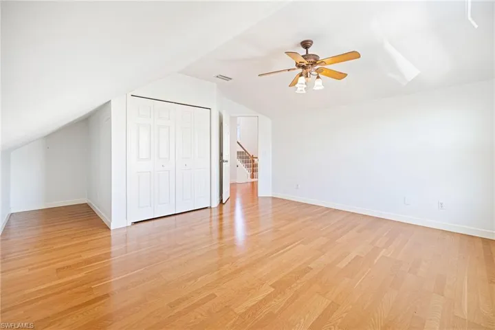 Second floor guest bedroom with lofted ceilings.