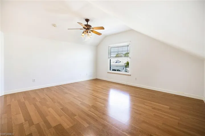 Second floor guest bedroom with lofted ceilings.