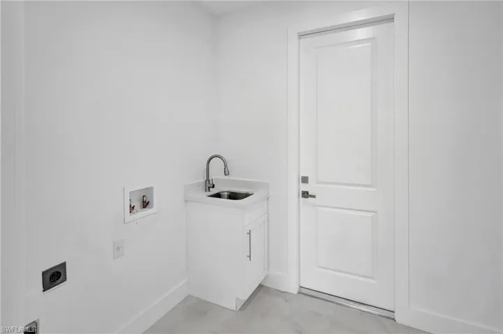 Laundry room featuring hookup for a washing machine, electric dryer hookup, and cabinet space