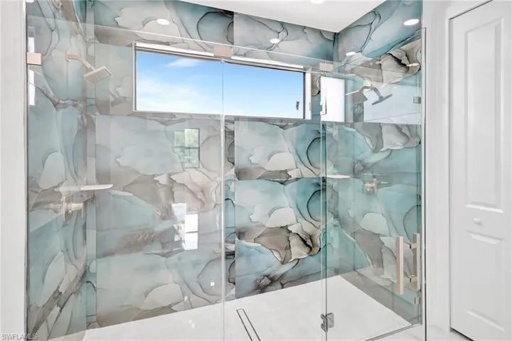 Bathroom featuring a marble finish shower