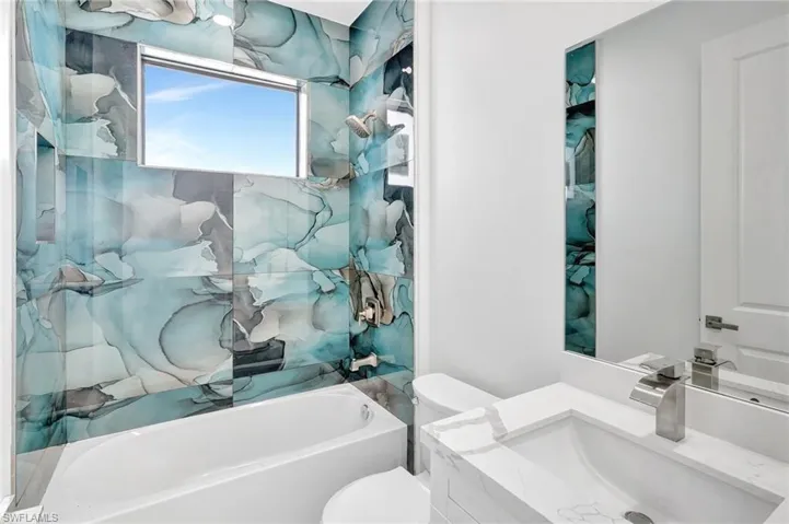 Bathroom with vanity and tub / shower combination