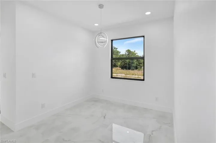 Unfurnished room featuring recessed lighting and light marble finish floors