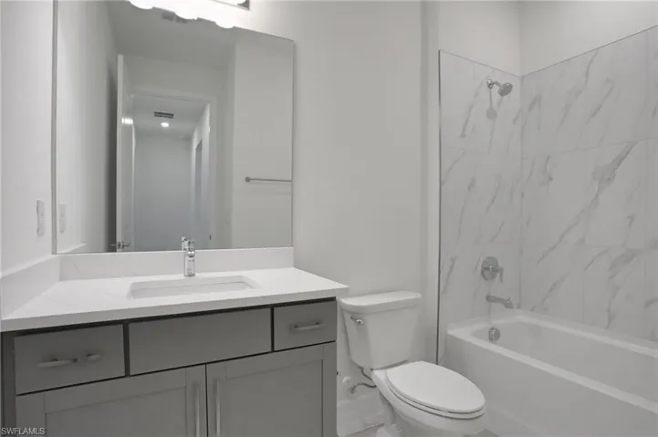 Full bathroom featuring washtub / shower combination and vanity