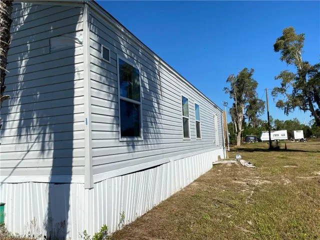 View of property exterior with a yard
