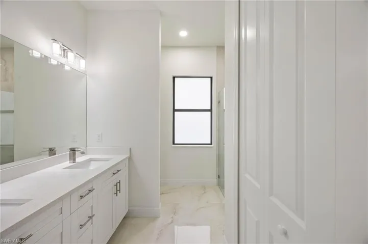 Bathroom featuring double sink vanity and tile floors