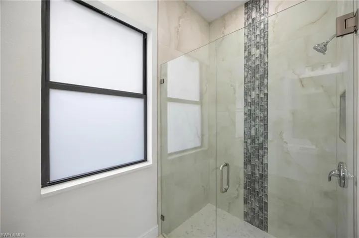 Bathroom featuring a shower with shower door