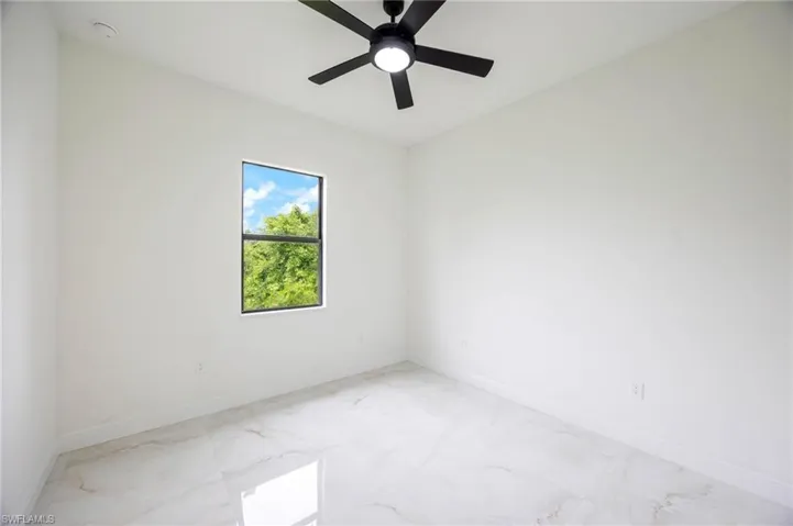 Tiled empty room with ceiling fan