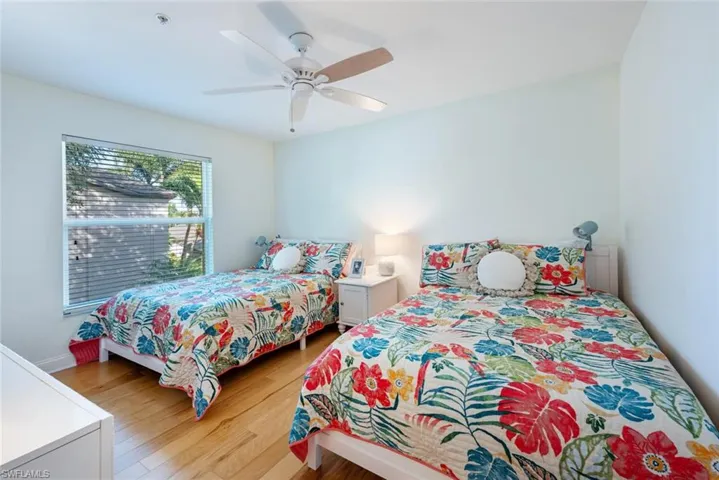 Bedroom with light wood-style flooring and a ceiling fan