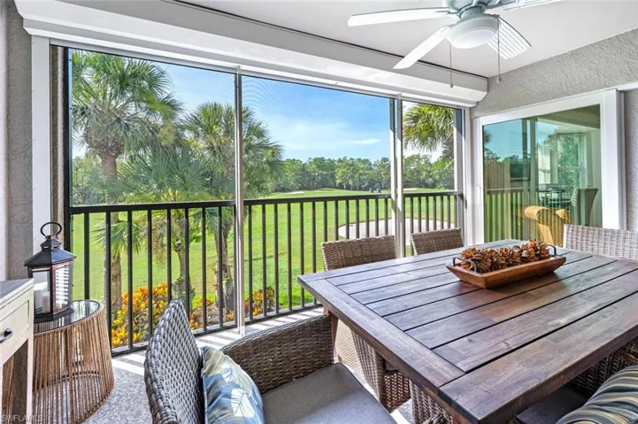 Sunroom / solarium featuring plenty of natural light, view of scattered trees, and golf course view