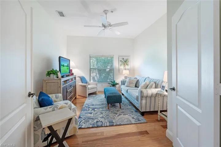 Living area featuring light wood-type flooring and ceiling fan