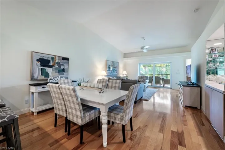 Dining space featuring vaulted ceiling, light wood-type flooring, and ceiling fan