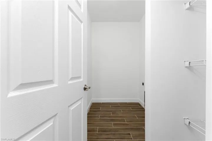Walk in closet featuring wood finish floors