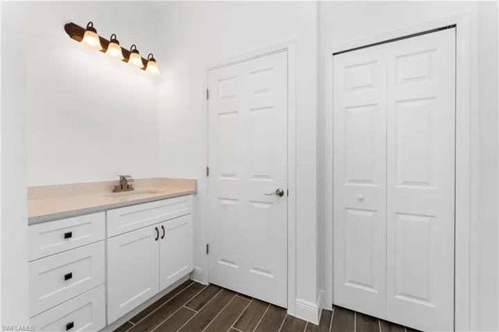 Bathroom with vanity and wood tiled floors