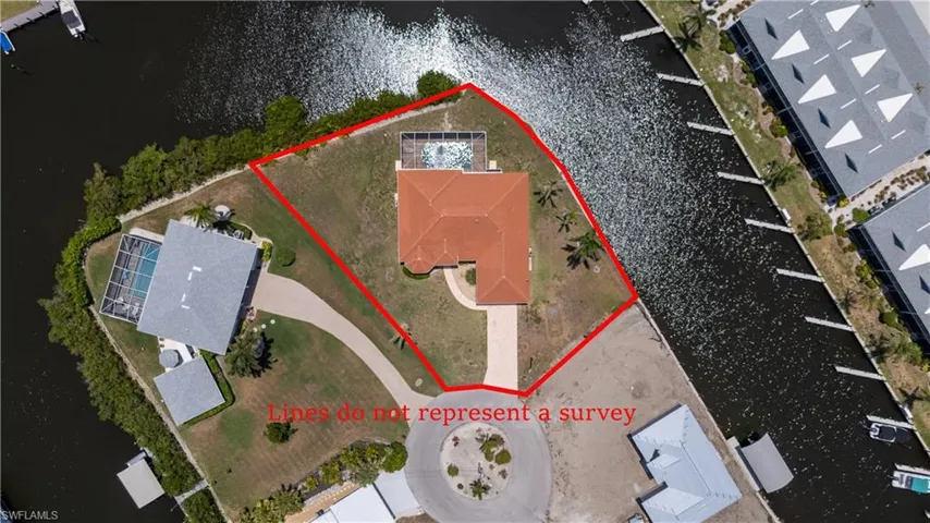 Aerial view of property and surrounding area featuring property parcel outlined and a large body of water