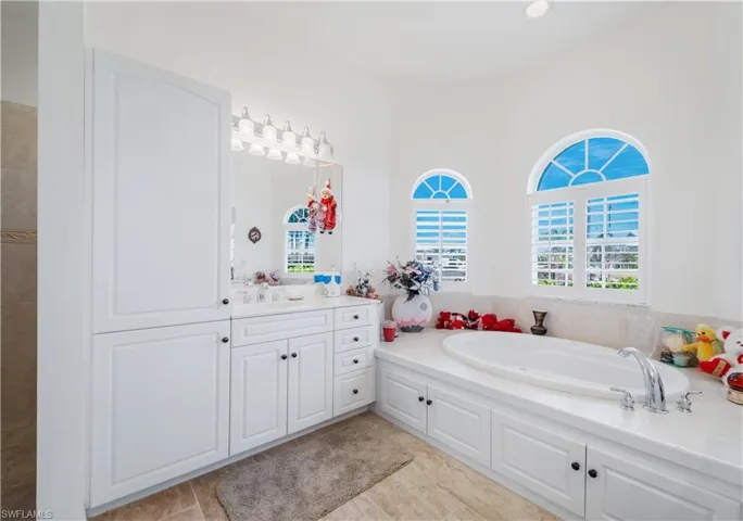 Bathroom featuring vanity and a garden tub