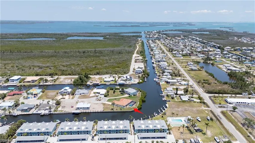 Aerial overview of property's location with a nearby body of water and nearby suburban area