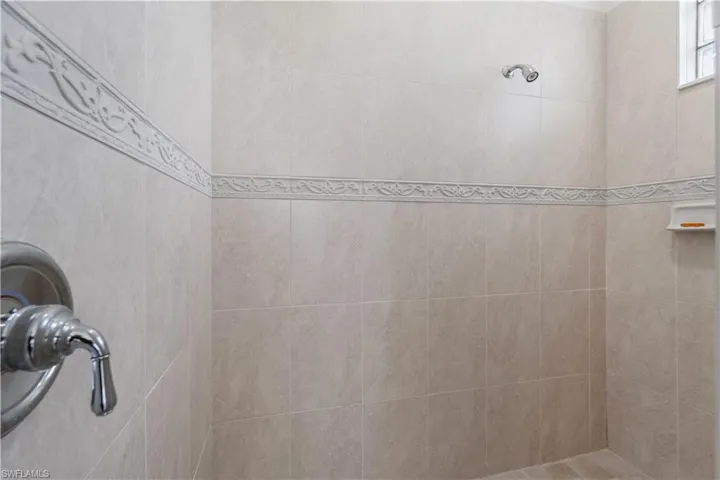 Full bathroom featuring a tile shower