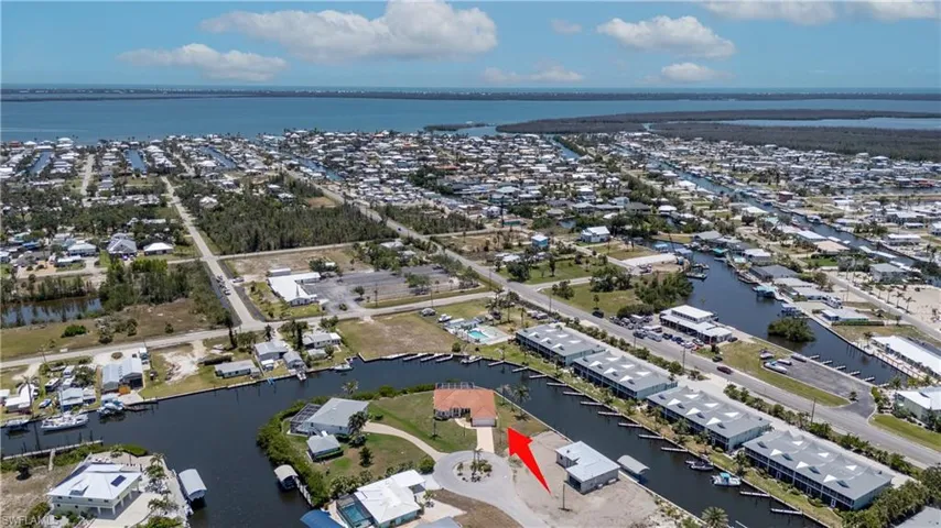 Aerial view of residential area featuring a nearby body of water