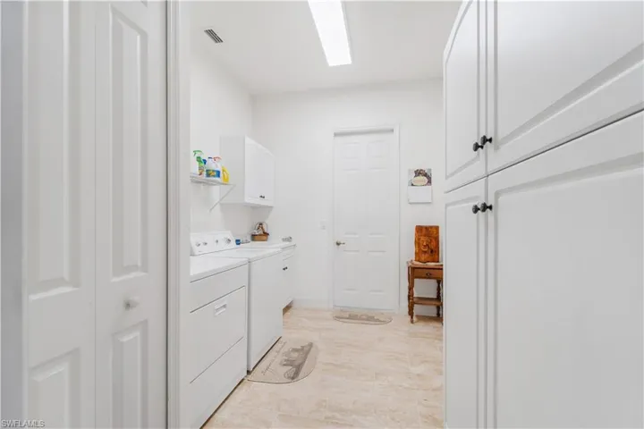 Laundry area featuring cabinet space and washer and clothes dryer