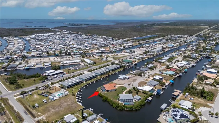 Aerial overview of property's location with a nearby body of water and nearby suburban area