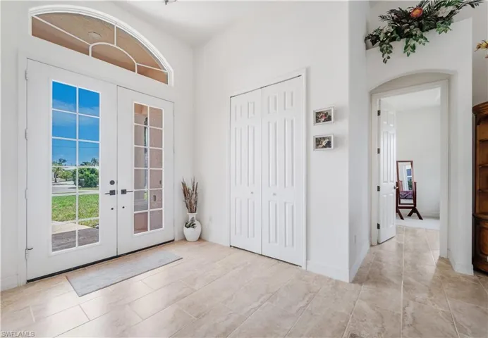 Foyer featuring french doors and arched walkways