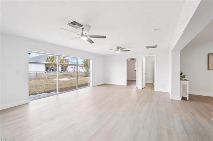 Unfurnished room featuring light wood finished floors and a ceiling fan