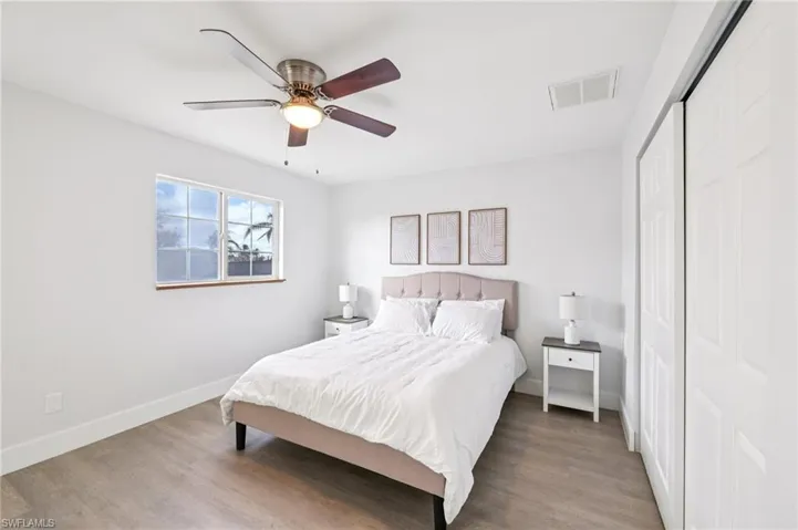 Bedroom with a closet, wood finished floors, and a ceiling fan