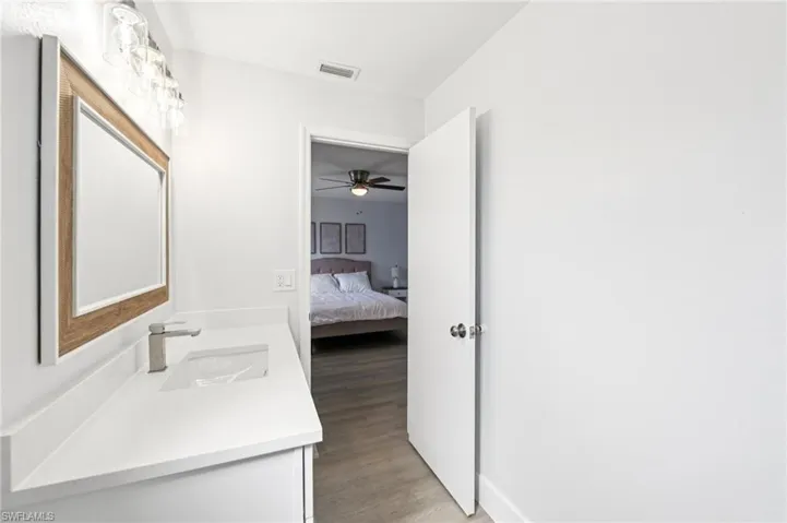 Ensuite bathroom with vanity and light wood finished floors