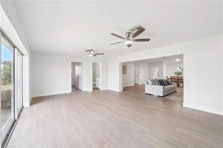 Living room featuring light wood-type flooring and a ceiling fan