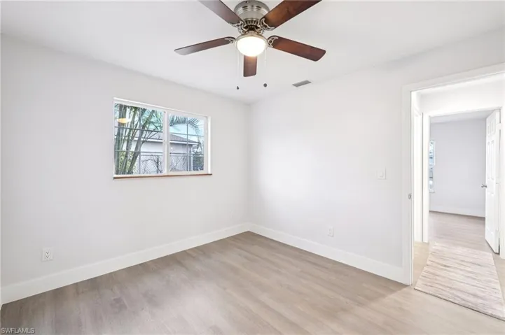 Empty room with light wood-style flooring and a ceiling fan