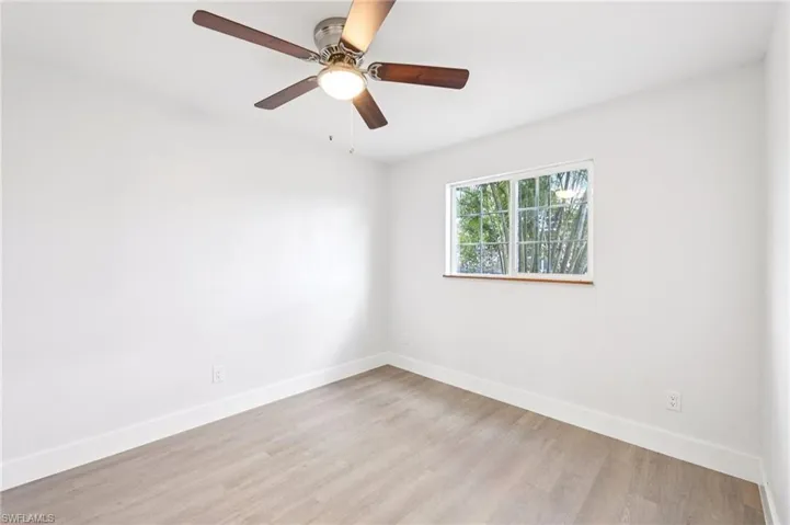 Unfurnished room with a ceiling fan and light wood finished floors