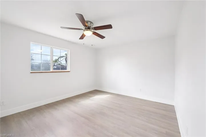 Unfurnished room featuring light wood-type flooring and ceiling fan