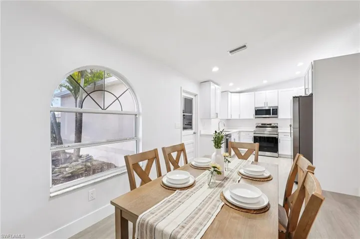 Dining room featuring light wood-style floors, recessed lighting, and vaulted ceiling
