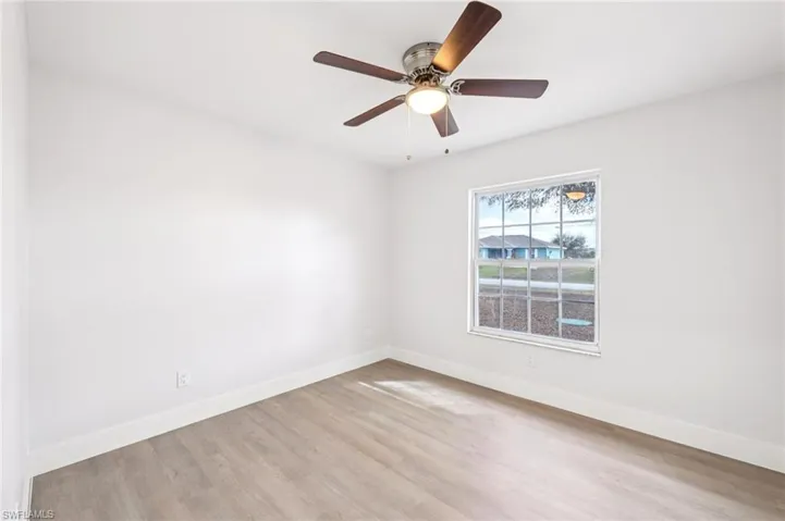 Unfurnished room with light wood finished floors and a ceiling fan