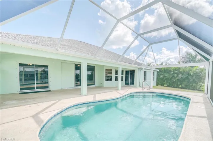 View of swimming pool with a lanai and a patio
