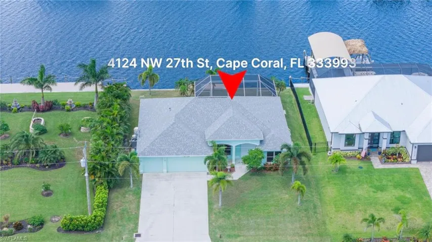 Birds eye view of property with a water view