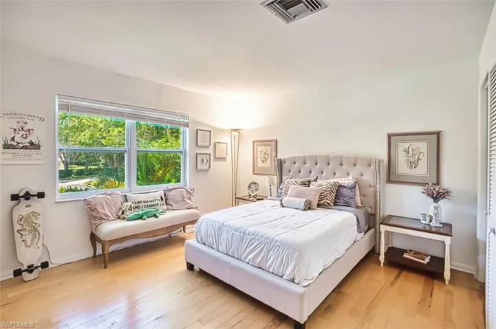 Bedroom with light wood-style floors and baseboards