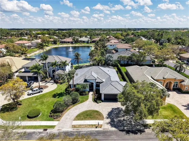 Aerial view of residential area featuring a nearby body of water