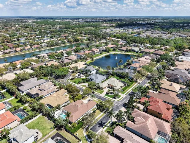 Aerial perspective of suburban area featuring a large body of water