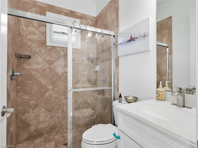 Bathroom with vanity and a stall shower