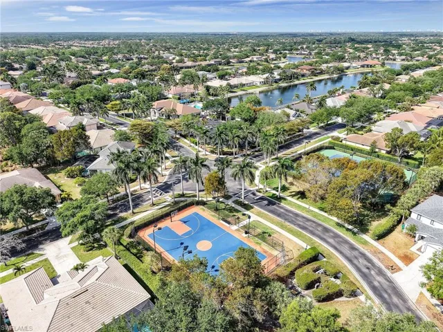 Aerial perspective of suburban area with a nearby body of water