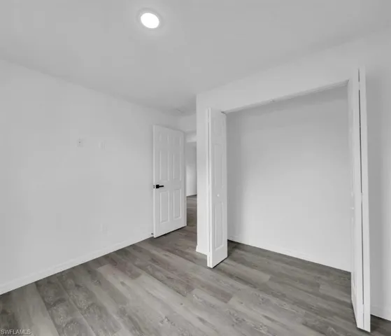 Unfurnished bedroom featuring light wood-type flooring and a closet