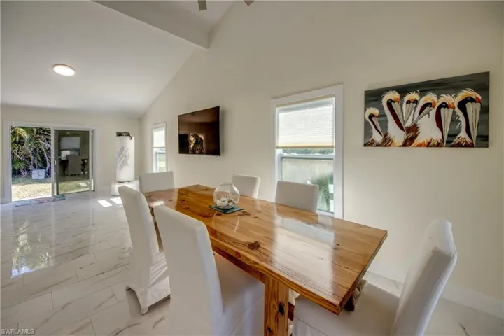 Dining space featuring light marble finish floors and healthy amount of natural light